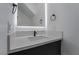 Modern bathroom featuring a marble countertop, black faucet, and illuminated mirror at 1316 Eagle Meadow Ct, Las Vegas, NV 89123