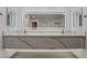 This bathroom features a quartz countertop with dual sinks and a large mirror with integrated lighting at 1316 Eagle Meadow Ct, Las Vegas, NV 89123