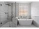 Stunning bathroom featuring glass shower, and soaking tub near a window at 1316 Eagle Meadow Ct, Las Vegas, NV 89123
