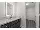 Modern bathroom featuring stylish vanity with quartz countertop, sleek fixtures, and an illuminated mirror at 1316 Eagle Meadow Ct, Las Vegas, NV 89123