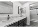 Modern bathroom with double sinks, quartz countertop, framed mirrors, and a glass enclosed shower at 1316 Eagle Meadow Ct, Las Vegas, NV 89123