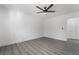 Bright bedroom showcases gray wood-look flooring, neutral walls, ceiling fan, and plenty of space at 1316 Eagle Meadow Ct, Las Vegas, NV 89123