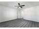 Spacious bedroom features sleek gray flooring, a modern ceiling fan, and ample natural light from the window at 1316 Eagle Meadow Ct, Las Vegas, NV 89123