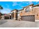 Spacious three-car garage showcasing the home's beautiful stone and stucco exterior and driveway at 1316 Eagle Meadow Ct, Las Vegas, NV 89123