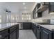 Well-equipped kitchen featuring dark cabinetry, stainless appliances, and granite countertops at 1316 Eagle Meadow Ct, Las Vegas, NV 89123