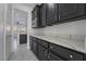Elegant kitchen features marble countertops, dark cabinets, and modern appliances at 1316 Eagle Meadow Ct, Las Vegas, NV 89123