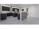 Modern kitchen featuring dark cabinets, stainless steel appliances, and stone accent wall at 1316 Eagle Meadow Ct, Las Vegas, NV 89123