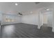 Bright and airy living room with stylish gray laminate flooring and modern ceiling fan at 1316 Eagle Meadow Ct, Las Vegas, NV 89123