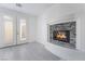 Inviting living room features tiled floors, a cozy fireplace, and access to the outdoors through French doors at 1316 Eagle Meadow Ct, Las Vegas, NV 89123