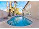 Backyard pool with a spa, blue tile accents, desert landscaping, and turf at 1316 Eagle Meadow Ct, Las Vegas, NV 89123