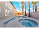 Backyard pool with a spa, desert landscaping, and two-story home in the background at 1316 Eagle Meadow Ct, Las Vegas, NV 89123