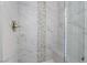 Modern shower featuring marble tile walls and decorative pebble accents, creating a luxurious spa-like experience at 1316 Eagle Meadow Ct, Las Vegas, NV 89123