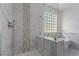 Close-up of a tiled shower with glass doors and modern fixtures at 1316 Eagle Meadow Ct, Las Vegas, NV 89123