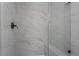 Modern shower featuring marble tile walls and sleek glass enclosure, enhancing the bathroom's contemporary design at 1316 Eagle Meadow Ct, Las Vegas, NV 89123