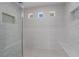A glass enclosed shower has dual seating, tile accents, and streams of natural light at 1316 Eagle Meadow Ct, Las Vegas, NV 89123