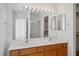Bathroom featuring double sinks, a vanity with wood cabinets, and a large mirror at 1351 Fawn St, Pahrump, NV 89048