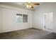 Vaulted ceiling bedroom featuring natural light, a ceiling fan, and neutral carpet at 1351 Fawn St, Pahrump, NV 89048