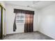Cozy bedroom with a window, curtains, and mirrored closet doors at 1351 Fawn St, Pahrump, NV 89048