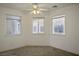 Well-lit bedroom with three windows and ceiling fan at 1351 Fawn St, Pahrump, NV 89048