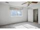 Bright bedroom with a large window allowing ample natural light, complemented by a ceiling fan at 1351 Fawn St, Pahrump, NV 89048