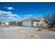 A single-story home boasts a clean two-car garage and low maintenance desert landscaping at 1351 Fawn St, Pahrump, NV 89048