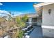 Inviting front entrance with covered porch, secure gate, xeriscape and textured concrete path at 1351 Fawn St, Pahrump, NV 89048