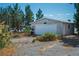 Detached garage on a large property, surrounded by mature trees and native landscaping at 1351 Fawn St, Pahrump, NV 89048