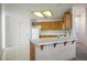 Functional kitchen with tiled countertops, wooden cabinets, and appliances at 1351 Fawn St, Pahrump, NV 89048
