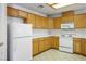 Kitchen featuring tile countertops, wooden cabinets, and appliances at 1351 Fawn St, Pahrump, NV 89048