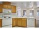 Kitchen with tile countertops, wooden cabinets, and essential appliances at 1351 Fawn St, Pahrump, NV 89048