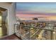 Enjoy panoramic city views from the balcony with glass railings at dusk at 150 N Las Vegas Blvd # 804, Las Vegas, NV 89101