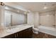 Bathroom featuring double sinks, granite counters, and combined bathtub/shower with patterned wall at 150 N Las Vegas Blvd # 804, Las Vegas, NV 89101