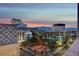 A high-angle view capturing hotels, palm trees, and a distant mountain range at dusk at 150 N Las Vegas Blvd # 804, Las Vegas, NV 89101