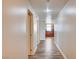 Long hallway view with wood floors leading to kitchen featuring wood cabinets and granite countertops at 150 N Las Vegas Blvd # 804, Las Vegas, NV 89101