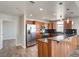 Modern kitchen features stainless steel appliances, wood cabinets, breakfast bar, and black granite countertops at 150 N Las Vegas Blvd # 804, Las Vegas, NV 89101