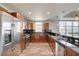 Gourmet kitchen features stainless steel appliances, granite countertops, and wood cabinets with an adjacent living area at 150 N Las Vegas Blvd # 804, Las Vegas, NV 89101