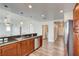 Modern kitchen features stainless steel appliances, breakfast bar, and a peek into the adjacent hallway and powder room at 150 N Las Vegas Blvd # 804, Las Vegas, NV 89101