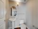 Powder room with pedestal sink, modern light fixture, and wood floors at 150 N Las Vegas Blvd # 804, Las Vegas, NV 89101