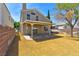 The home features a covered patio and a spacious backyard with desert-friendly landscaping and secure brick fencing at 1724 Navajo Lake Way, Las Vegas, NV 89128