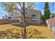 Expansive backyard with covered patio, surrounded by brick privacy wall and desert landscaping with mature tree at 1724 Navajo Lake Way, Las Vegas, NV 89128