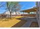 Low-maintenance backyard with desert landscaping, covered patio, and brick perimeter wall for enhanced privacy at 1724 Navajo Lake Way, Las Vegas, NV 89128