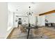 Dining area adjacent to a modern kitchen with white cabinets and stainless steel appliances at 1724 Navajo Lake Way, Las Vegas, NV 89128