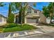 Attractive two-story home with a two-car garage, green lawn, and mature trees offering a peaceful setting at 1724 Navajo Lake Way, Las Vegas, NV 89128