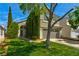 Lovely two-story home featuring a two-car garage, well-maintained lawn, and lush landscaping for curb appeal at 1724 Navajo Lake Way, Las Vegas, NV 89128