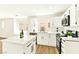 Bright kitchen featuring white cabinets, stainless steel appliances and an island with marble countertops at 1724 Navajo Lake Way, Las Vegas, NV 89128