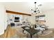 Bright living room with fireplace, wood beam, and dining area with modern light fixture at 1724 Navajo Lake Way, Las Vegas, NV 89128