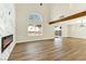 Bright living room boasts wood floors, modern fireplace with marble accent wall, and beam at 1724 Navajo Lake Way, Las Vegas, NV 89128