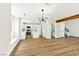 Spacious, open-concept living area adjacent to updated kitchen with island and wood floors at 1724 Navajo Lake Way, Las Vegas, NV 89128