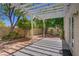 Outdoor patio with a pergola, privacy wall, trees, and lush landscaping at 1812 Relate Ct, Las Vegas, NV 89117