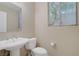 Simple bathroom with a pedestal sink, toilet, and a window with natural light at 1812 Relate Ct, Las Vegas, NV 89117